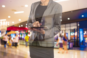 Businesswoman using digital tablet in the shopping mall.