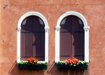 Fototapeta na wymiar two arch window and ancient decay orange wall