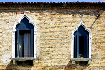 two windows and ancient brick wall