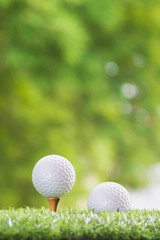 Golf ball on a tee peg and Golf ball on grass,