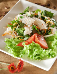 Spicy prawn thai salad. Appetizer of the squid with greens, served with a spicy sauce