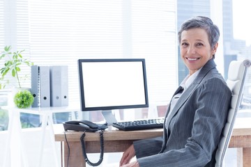 Smiling businesswoman using computer