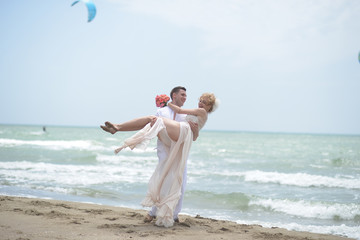 Smiling wedding couple on beach