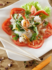 rice noodles with octopus and lemon grass under spicy dressing. spicy seafood salad in Thai style