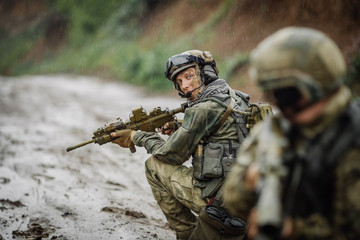 Fototapeta premium Portrait of a ranger in the battlefield with a gun