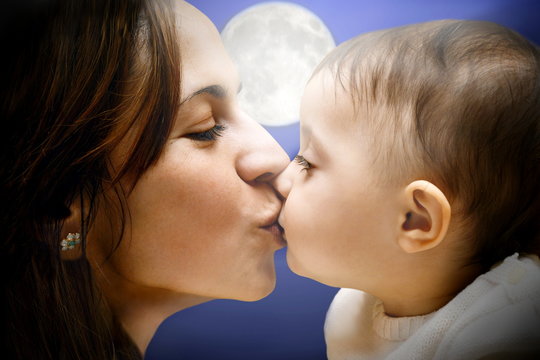 Mother Kissing Baby Under Moonlight Shadow Outdoor