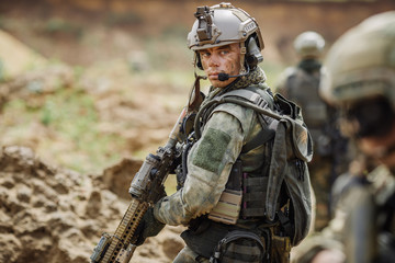 Portrait of a ranger in the battlefield with a gun