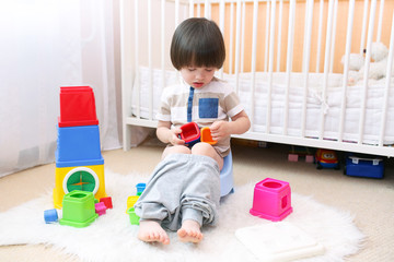 Cute little boy sitting on potty at home