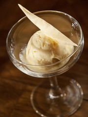 scoop of vanilla ice cream. homemade ice cream dessert in a glass on a dark background
