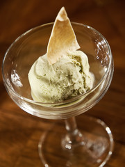 homemade ice cream. scoop of pistachio ice cream in a glass on dark background