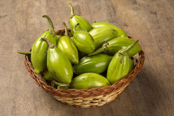 Some green african eggplants over a wooden surface