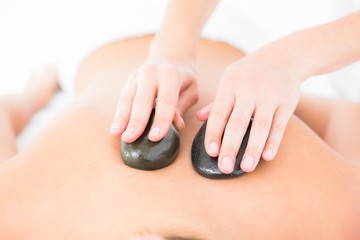 Woman enjoying a hot stone massage 