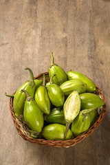 Some green african eggplants over a wooden surface