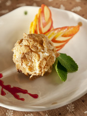 Delicious restaurant dessert, fried ice cream served with slices apple and fruit coulis