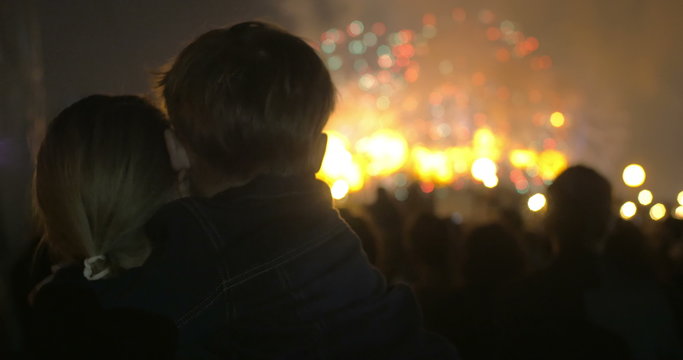 Mother and little son watching fireworks