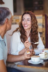  Casual couple having coffee and cake together