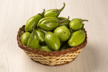 Some green african eggplants over a white background