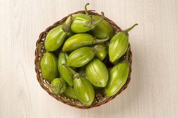 Some green african eggplants over a white background