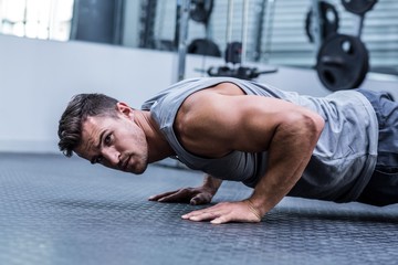 A muscular man doing a pushups 