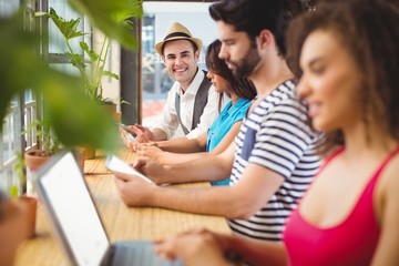 Happy friends using electronic devices