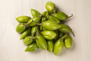 Some green african eggplants over a white background