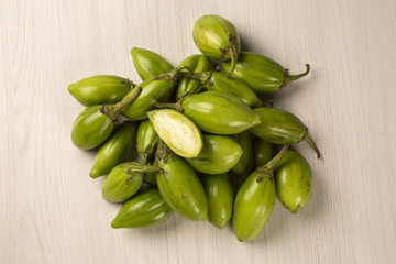 Some green african eggplants over a white background