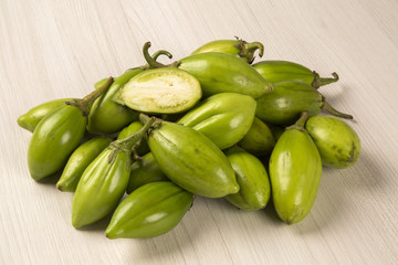 Some green african eggplants over a white background