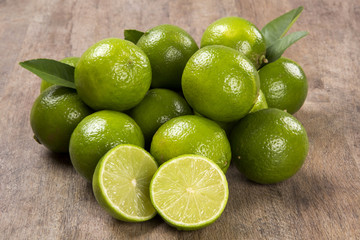 Fresh citrus lime with mint close up on wooden background