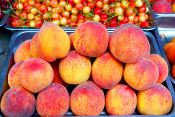 Peaches in the market. Sale of fruit.