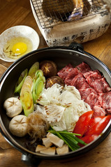 Sukiyaki. Stewed marbled beef with vegetables and sukiyaki sauce, served with egg yolk. japanese cuisine