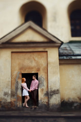 Obraz na płótnie Canvas cute romantic gentle beautiful redhead stylish girl and her boyfriend spend good time in lviv