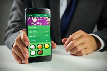 Composite image of businessman using smartphone