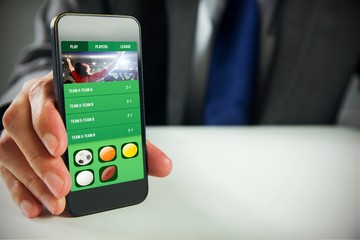 Composite image of businessman using smartphone