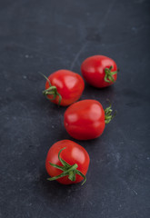 Ripe red tomatoes on black table