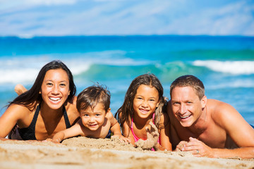 Happy Family Having Fun at the Beach - 87509309