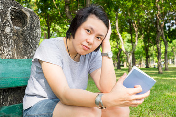 Woman reading book in the park
