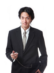 Naklejka premium Businessman looking a pocket watch,attractive asian man on white