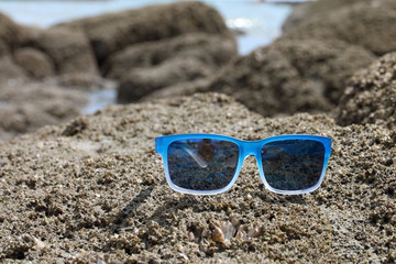 sunglasses on the stone seaside