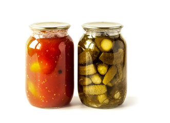 Salted cucumbers and tomatoes in glass jars isolated on white