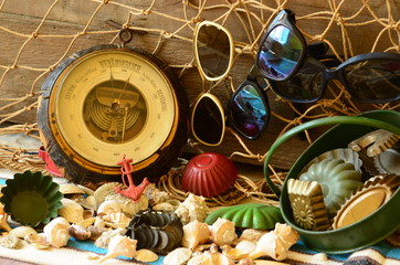 Vintage barometer, beam trawl, sunglasses and retro beach toys. Vintage summer