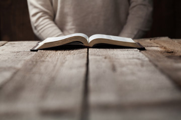 young girl writing into a book