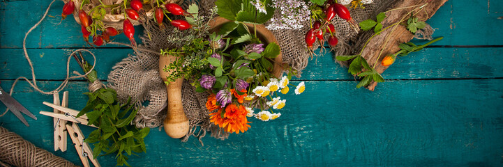 Summer fresh medicinal herbs on the wooden background. © ksu_ok