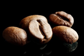 Macro closeup shot of coffee beans isolated on black