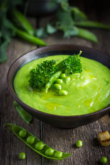 green pea soup on rustic background
