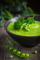 green pea soup on rustic background