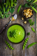 green peas soup on rustic background