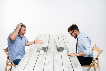 The two colleagues working together at office on white