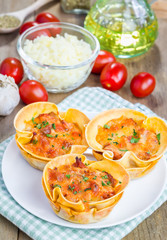 Homemade lasagna cups with minced meat, bolognese sauce topped with cheese