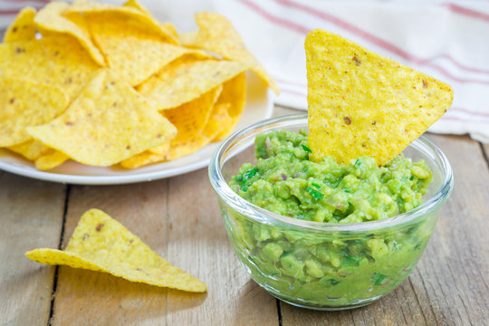 Bowl with chunky guacamole served with nachos