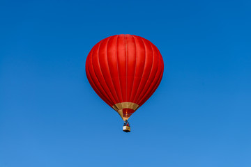 red hot air  balloon against the blue sky